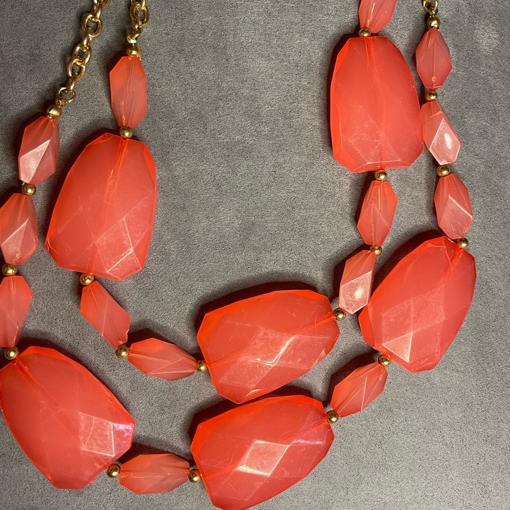 Costume jewelry necklace with beautiful pinkish orange stones